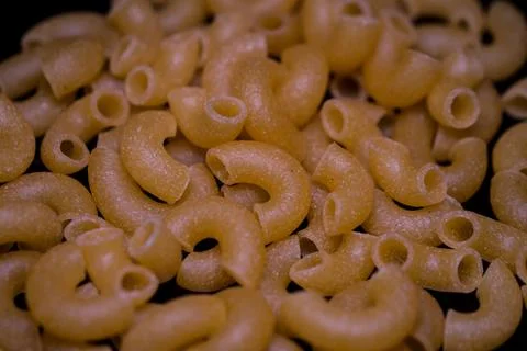 Raw yellow macaroni. Stock Photos