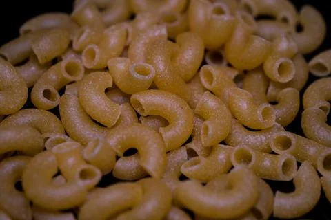 Raw yellow macaroni. Stock Photos