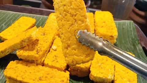 Raw Yellow Marinated Tempeh Slices Ready for Frying Stock Footage 339377407