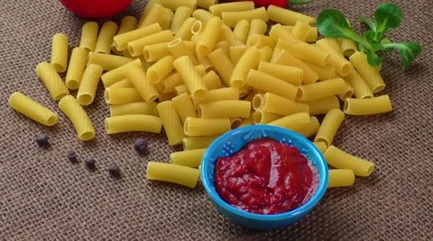 Raw yellow pasta, macaroni on sack background Stock Footage 59329134