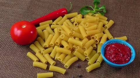 Raw yellow pasta, macaroni on sack background Stock Footage 61485214