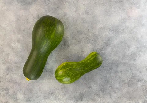Raw zucchini on a light gray table. Top view, copy space Stock Photos