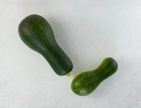 Raw zucchini on a light gray table. Top view, copy space Stock Photos