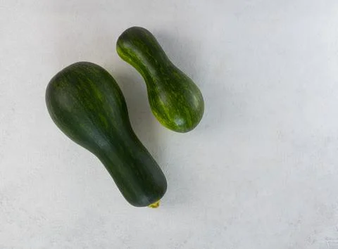 Raw zucchini on a light gray table. Top view, copy space Stock Photos
