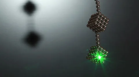 Ray of laser light on cube compound of magnet spheres Video stock 8547895