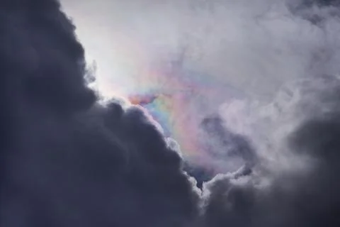 A ray of light from behind the clouds broken down into a spectrum, light disp Stock Photos