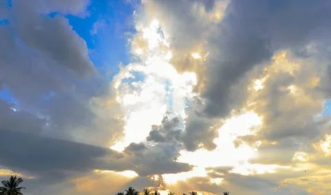 Ray of light breaks through the dramatic sky at sunset Stock Photos