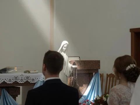 A ray of light falls on the holy statue during the wedding ceremony. Wedding  Stock Photos