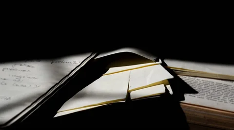 Ray of light moving along books scattered on the floor Video stock 65405456