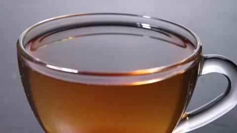 A ray of light pours over a cup of tea Stock Footage 156515050