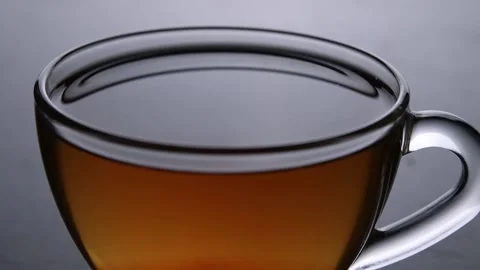 A ray of light pours over a cup of tea 動画素材 156704157