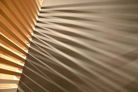  Ray lights through woodden pattern frame creating graphic shadows on gray... Stock Photos
