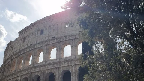 A ray of sun passes through the arches of the Colosseum in Rome, Italy. Stock Footage 112671809