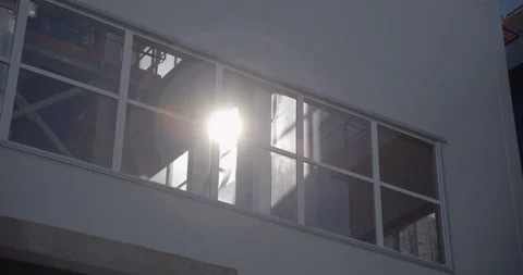 A ray of sun shines through the large windows in the factory  Stock Footage 147634019