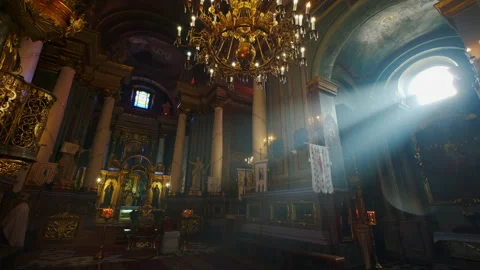 Ray of sunlight illuminates faces of saints in Orthodox Church. Move camera Stock Footage 167221006