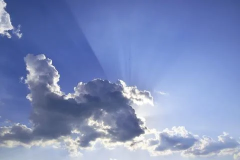 Ray tracing of the sun hidden behind a cloud in humid summer air Stock Photos