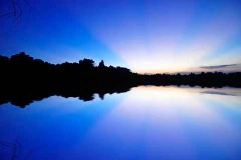 Rays and reflection on lake Stock Photos