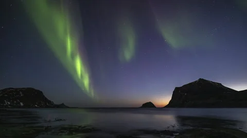 Rays of the Aurora Borealis moving over the undulating coast Stock Footage 251359062