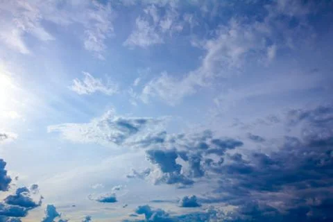 Rays on blue sky with cumulus clouds before the storm Stock Photos