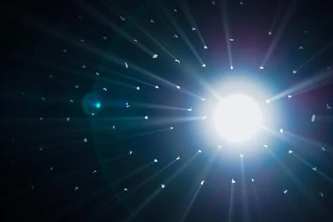 Rays of bright light come through holes in the black background of the studio Stock Photos