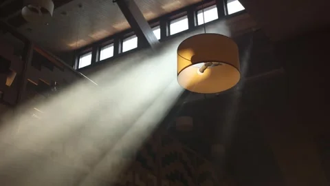 Rays of light break through the ceiling in the restaurant Stockbeeldmateriaal 286076835