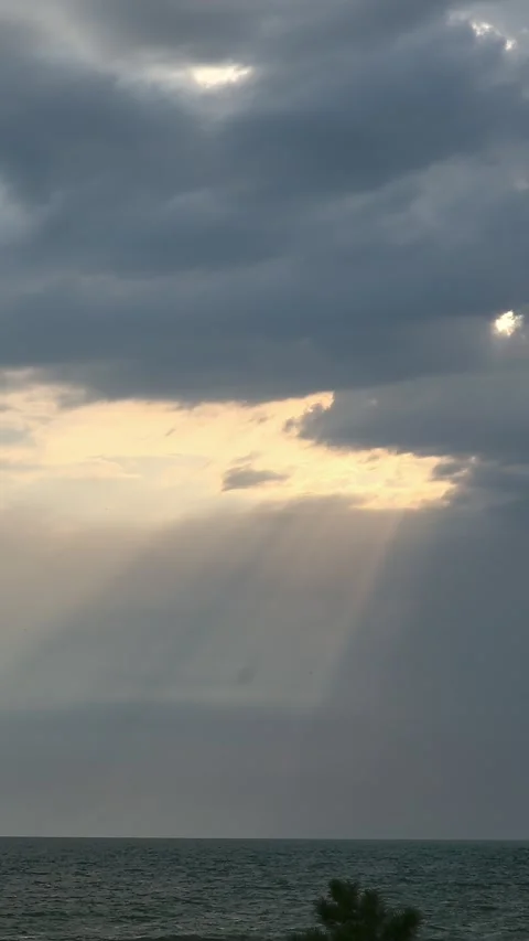Rays of light break through the dense clouds over the sea. Seascape Stock-Footage 254713354