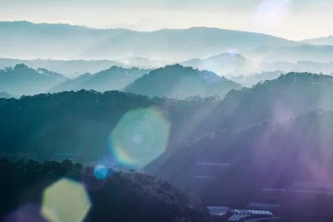 Rays light cross trees over mountain landscape Stock Photos