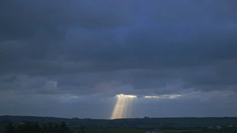 Rays of light cut through the cloudy sky and fall to the ground, light Video stock 243206398