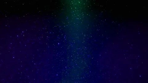 Rays of light of different colors flash on a shiny background 動画素材 195700707