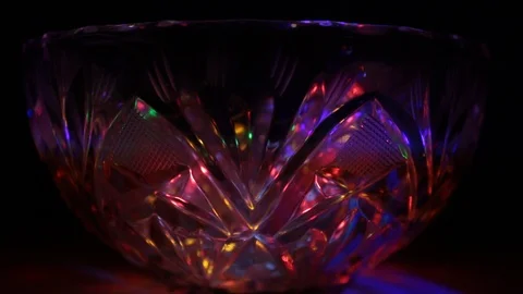 Rays of light of different colors sparkle on the edges of a crystal vase Stock Footage 107469632