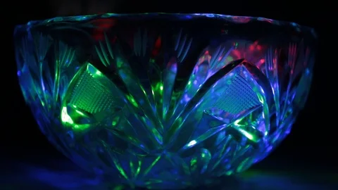 Rays of light of different colors sparkle on the edges of a crystal vase Stock Footage 107469684