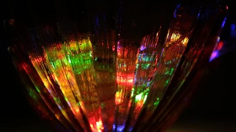 Rays of light of different colors sparkle on the edges of a crystal vase Stock Footage 107469736