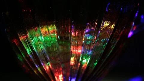 Rays of light of different colors sparkle on the edges of a crystal vase Stock Footage 107469775