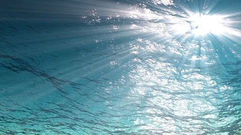Rays of light make their way through ocean waves from underwater looping Video stock 82765461