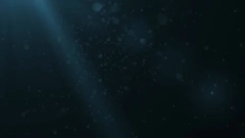 Rays of light shining from above penetrate deep clear blue water Stock Footage 114671797