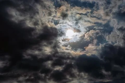 Rays of light shining throug dark clouds Stock Photos