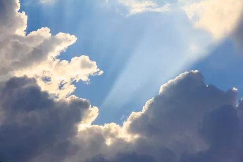 Rays of light shining through white clouds Stock Photos