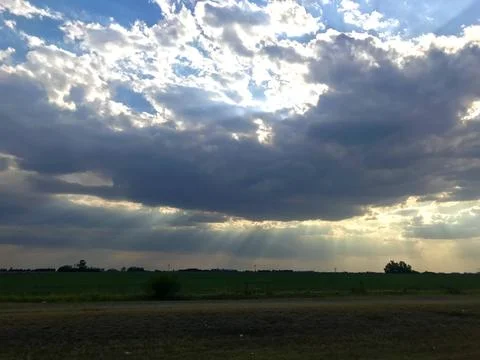 Rays of light throughout the clouds un the pamapas Stock Photos