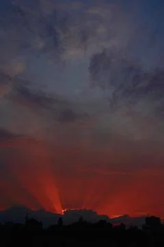 Rays make their way through the clouds Stock Photos