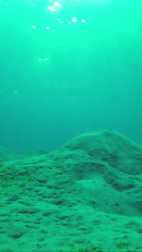 The rays of the morning sun break through the surface of the water Stock Footage 232766514