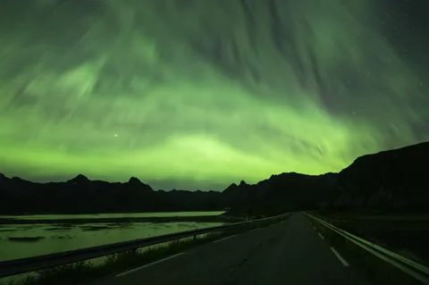 Rays of Northern Lights over the road Stock Footage 250788834