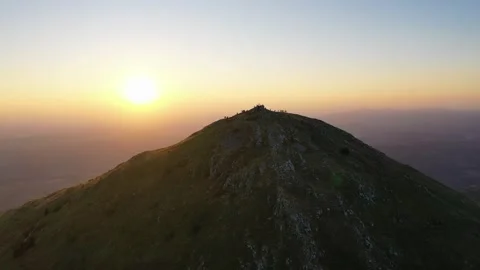 Rays of the rising sun in front of the Rtanj mountain peak Stock Footage 247968351