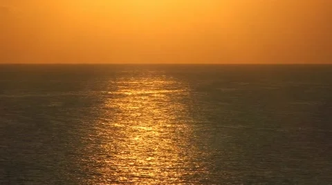 The rays of the rising sun reflected in the sea waves Stock Footage 53424763