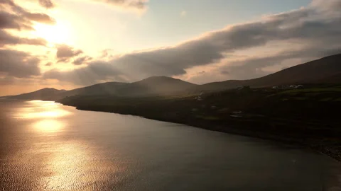 Rays of setting sun go through the cloudscape to the dark mountains Stock Footage 284857121