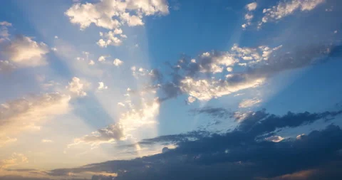 Rays of the setting sun make their way through dark clouds Stock Footage 94757947