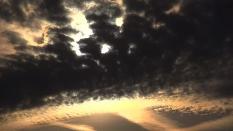 The rays of the setting sun make their way through the glowing clouds. Stock Footage 105294428