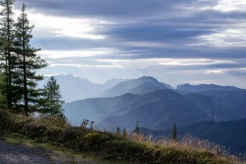 Rays of the setting sun over the Alpine mountains Stock Photos