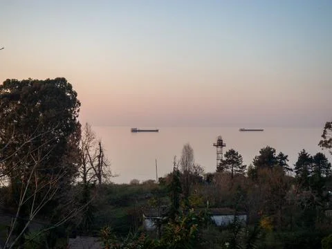 In the rays of the setting sun. Sea view. Barge on the sea horizon. Landsca.. Stock Photos