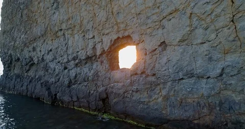 The rays of the setting sun through a hole Stock Footage 129901558