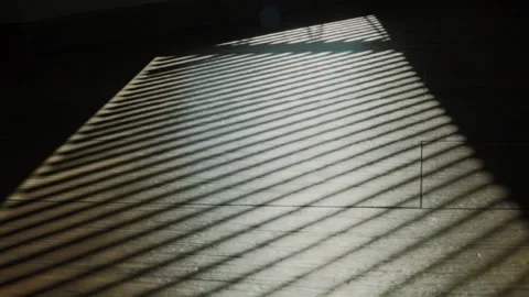Rays of setting sun through the roller blinds on window, Sunshine over the Video stock 148453238